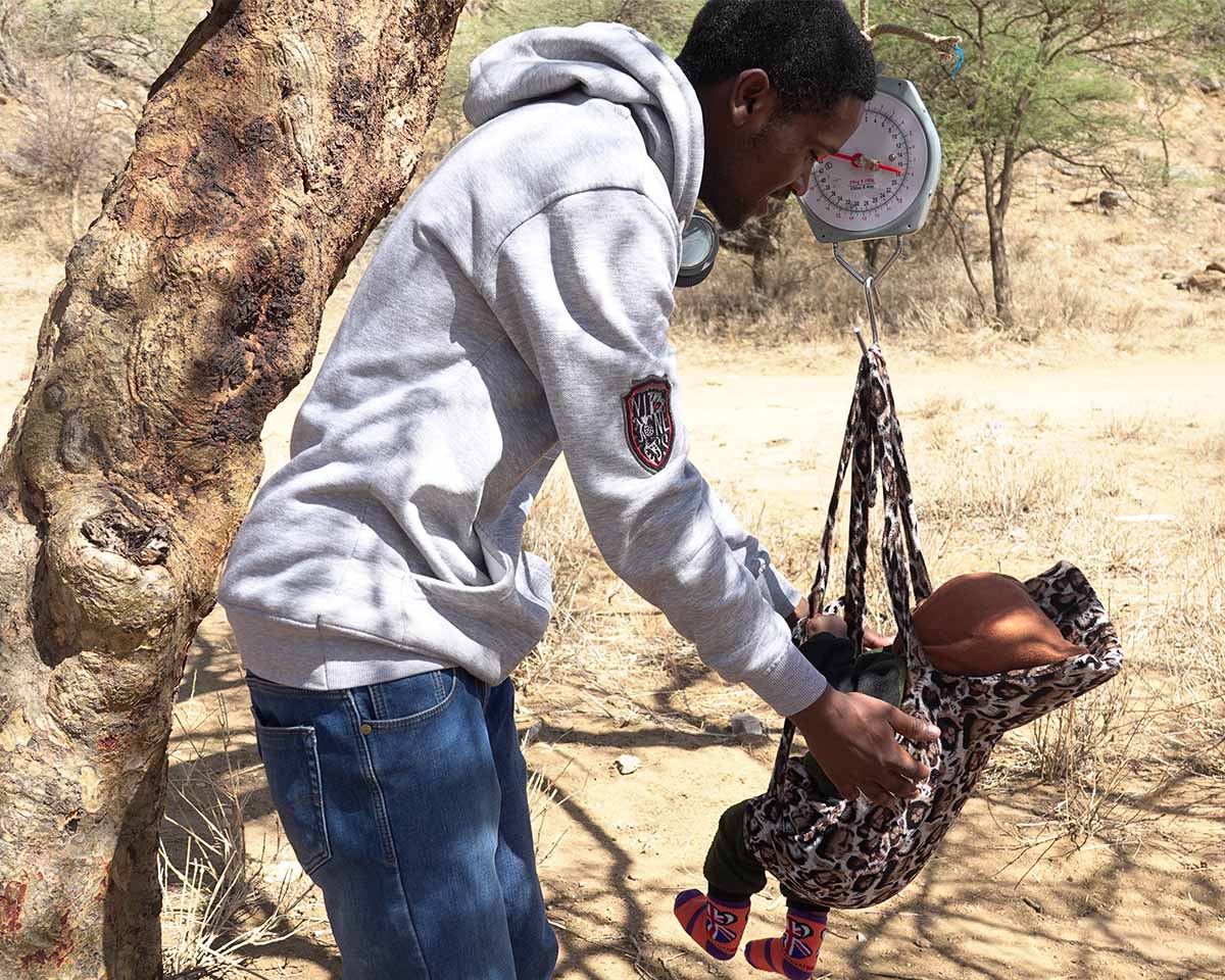 A baby being weighed in a remote clinic in one of Tanzania's villages