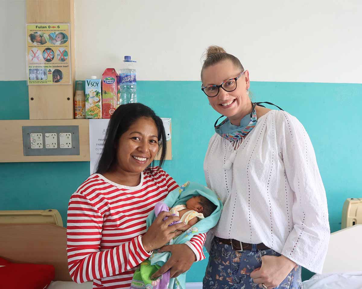 A member of MAF visiting Cecilia and her baby in the hospital after she was medically evacuated