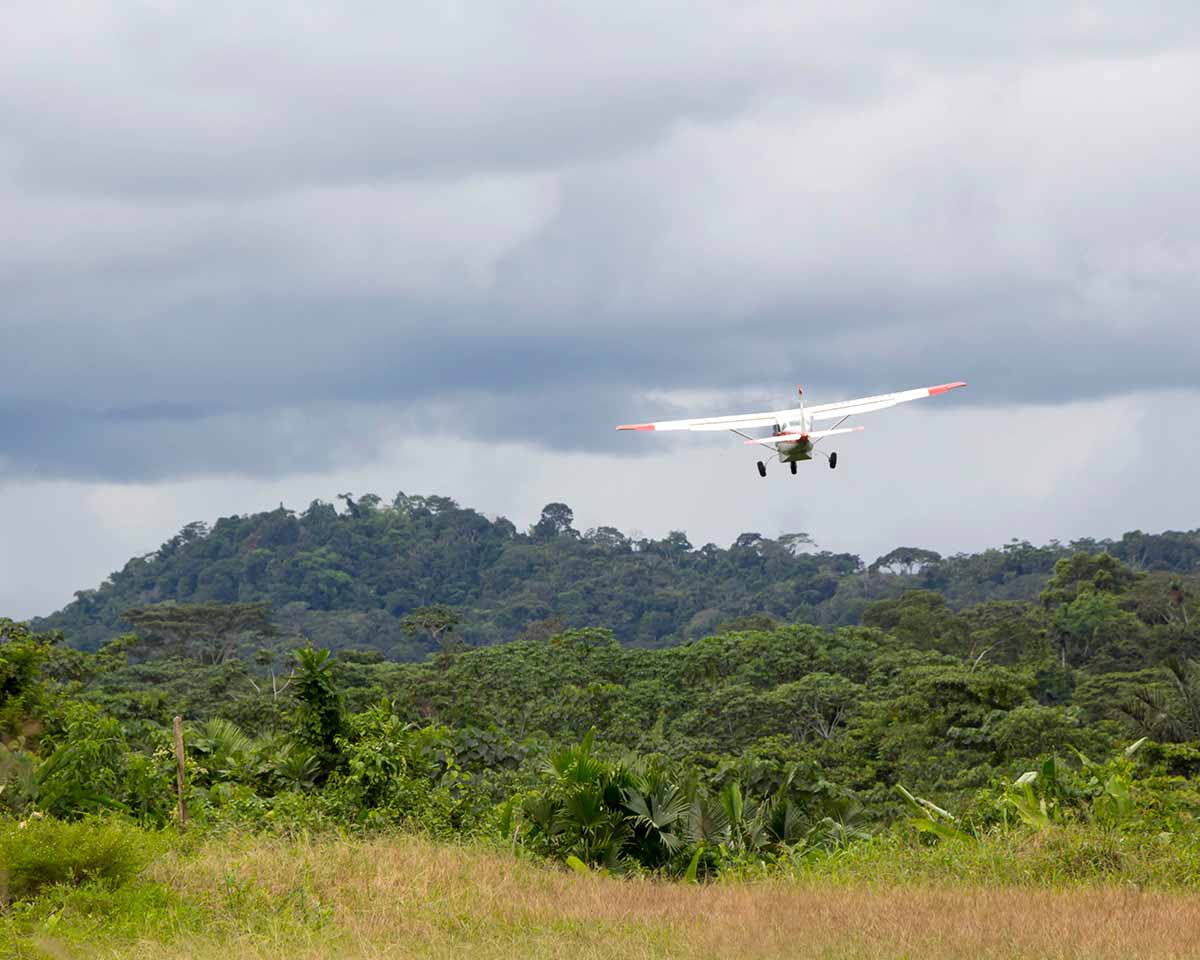 An MAF plane flying over the thick shrubbery in Ecuador