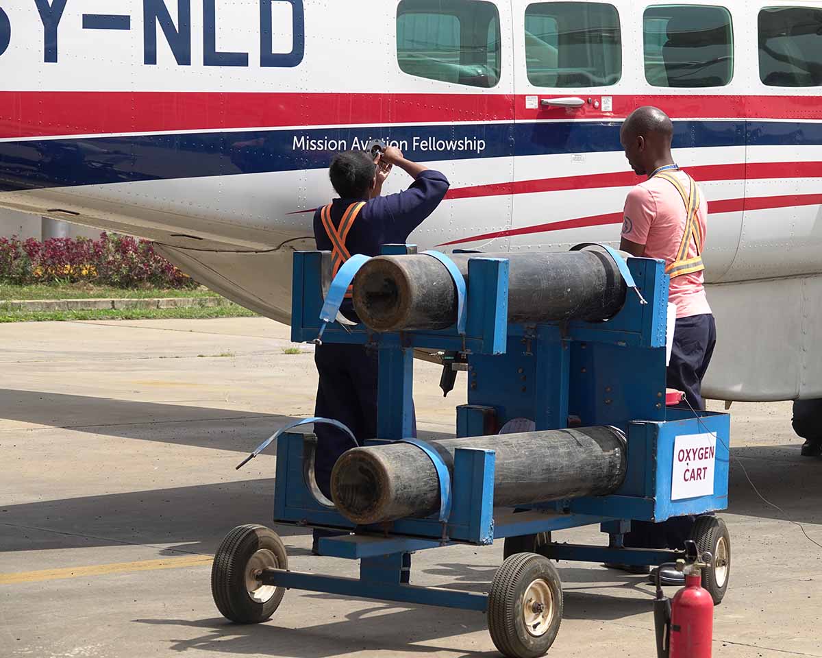 MAF Kenya Engineer Davies and Christine working on oxygen replenishment for one of the planes