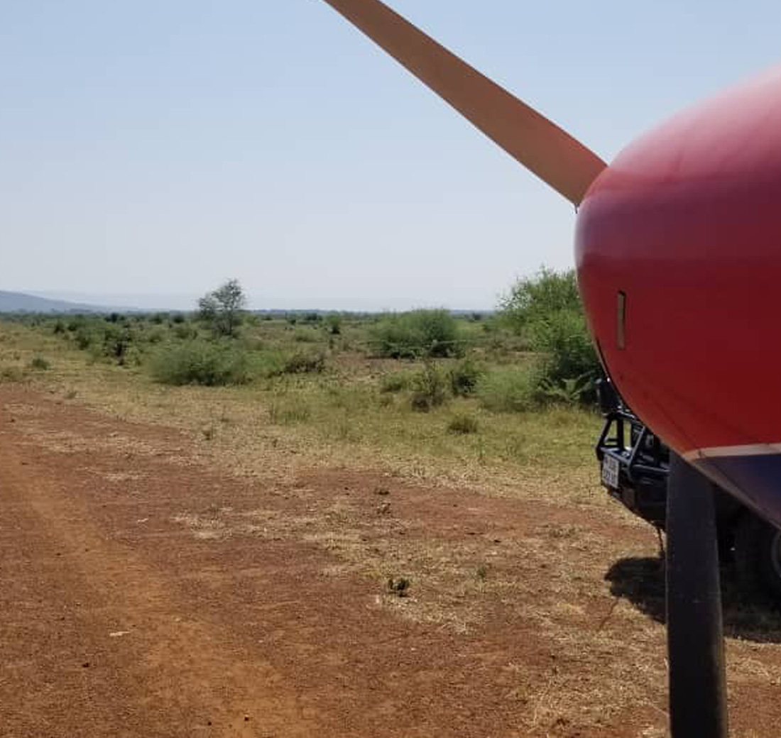One of MAF's aircrafts facing the runway having just landed near a village in South Sudan